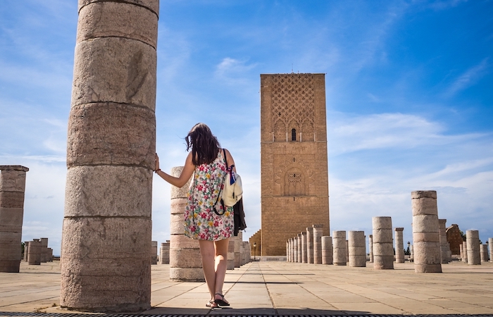 A female tourist enjoying the beautiful view of Tour Hassan in Rabat, Morocco