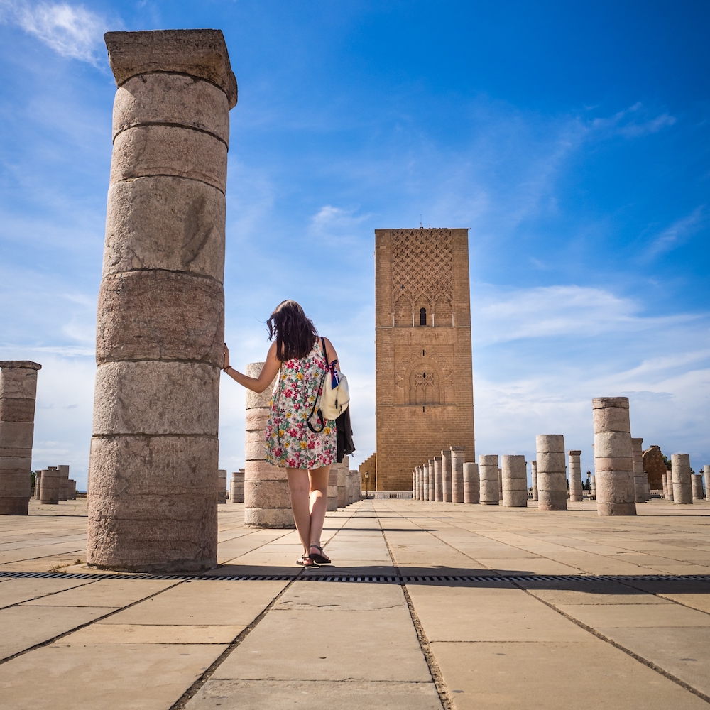 A female tourist enjoying the beautiful view of Tour Hassan in Rabat, Morocco